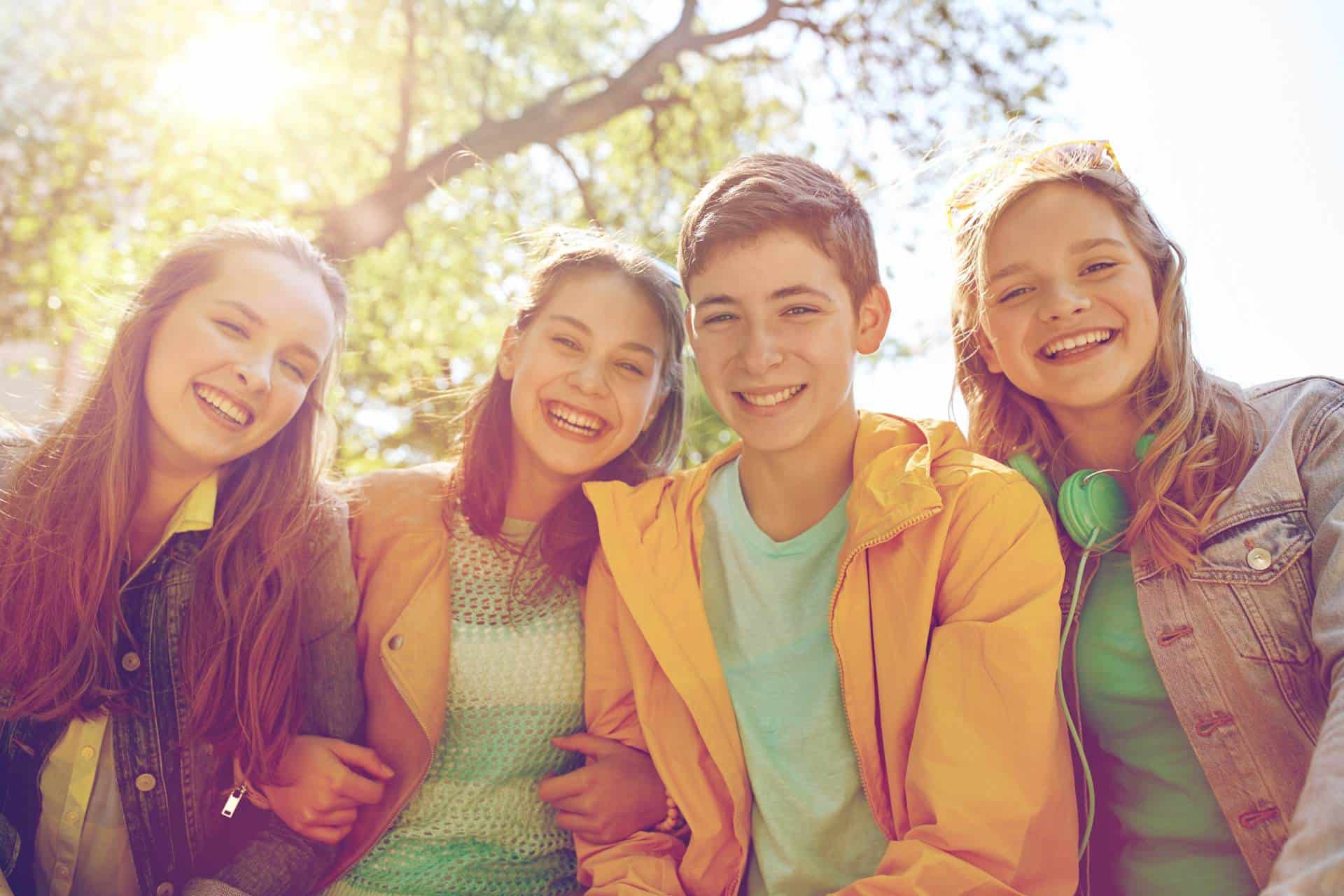 Group of teens smiling after orthodontic care from Farina Orthodontics in Tampa, FL